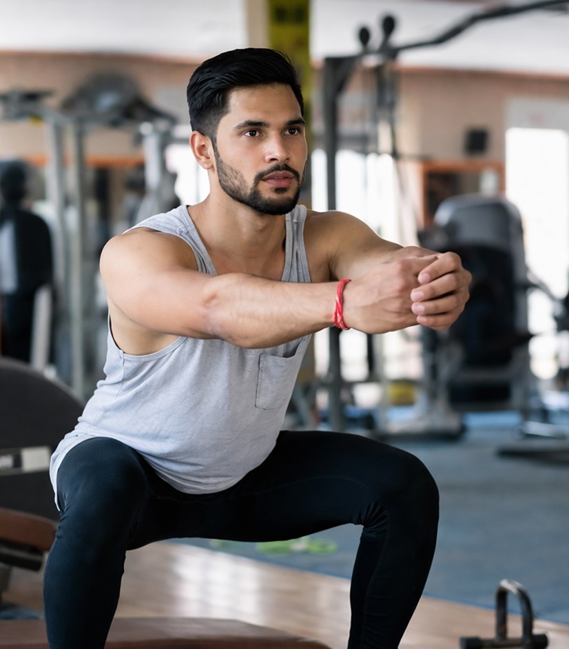 Man holding a squat during a gym workout